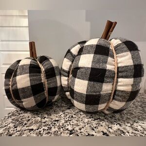 Two black and ivory buffalo check soft pumpkins.